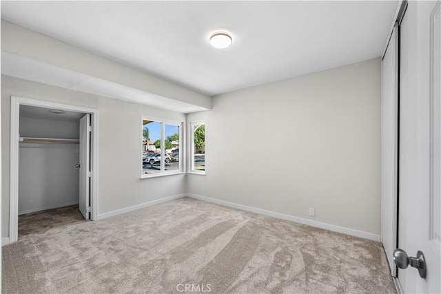 unfurnished bedroom featuring light colored carpet