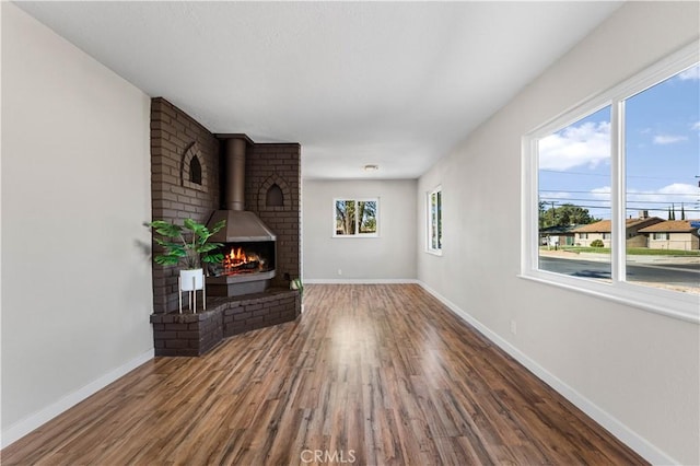 living room featuring a wood stove and hardwood / wood-style flooring