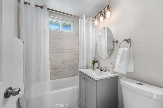 full bathroom with shower / bath combo with shower curtain, toilet, and vanity