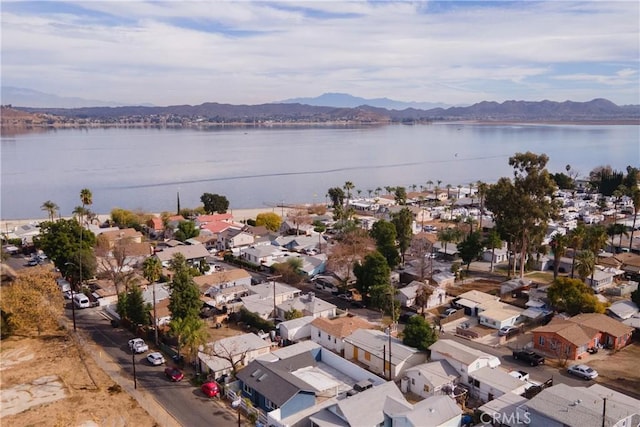 birds eye view of property with a water and mountain view