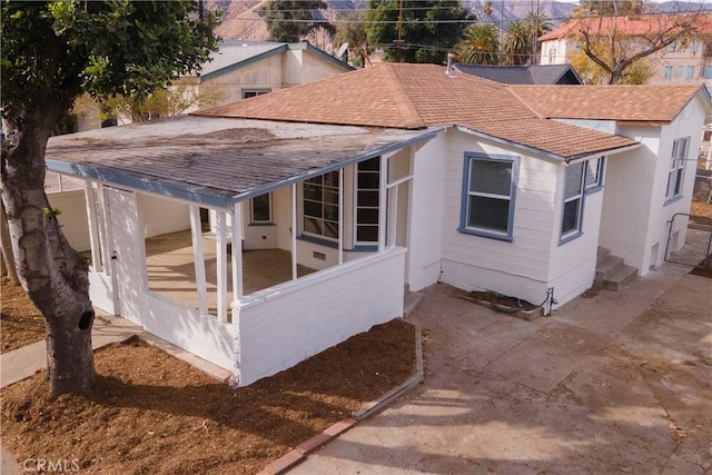 view of side of property featuring a patio