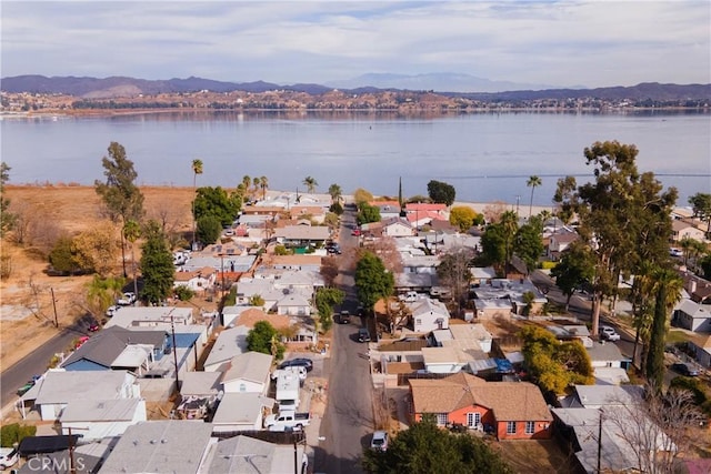 birds eye view of property with a water and mountain view