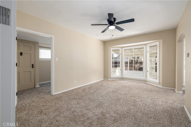 carpeted empty room featuring ceiling fan