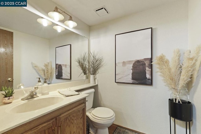 bathroom featuring toilet and vanity