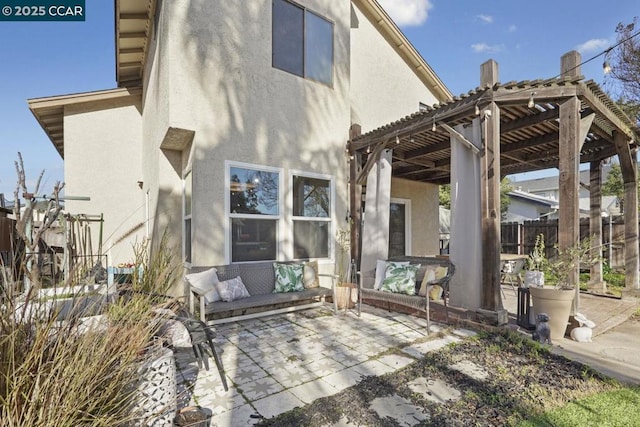 back of house with a pergola and a patio area