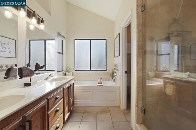 bathroom featuring tile patterned flooring, shower with separate bathtub, vanity, and vaulted ceiling