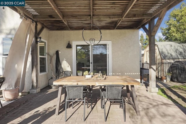 view of patio with grilling area and a pergola