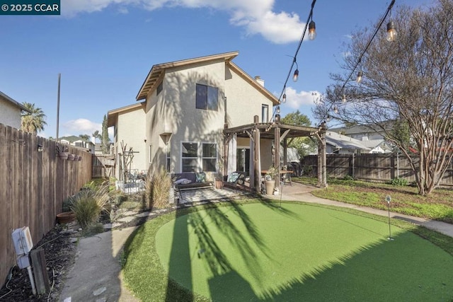 back of property with a pergola and a patio