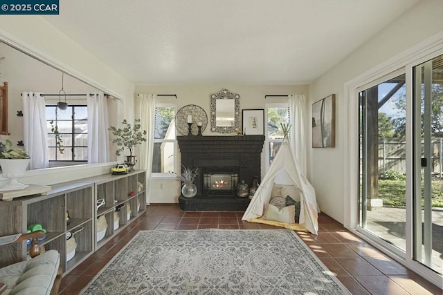 interior space with dark tile patterned flooring and a wealth of natural light