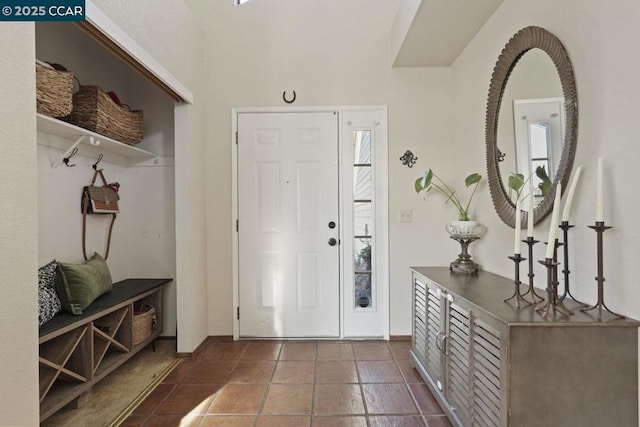 foyer entrance featuring dark tile patterned flooring