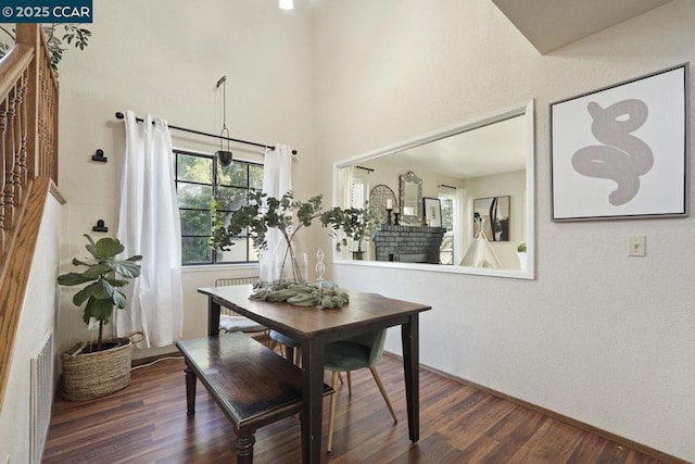 dining area featuring a fireplace and dark hardwood / wood-style floors