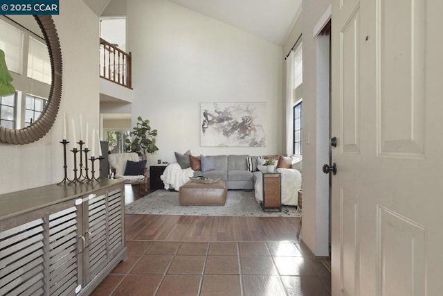 tiled entrance foyer featuring high vaulted ceiling