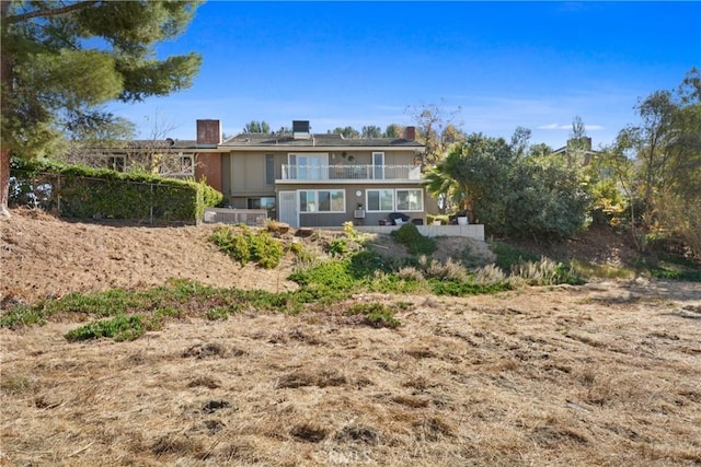 rear view of house with a balcony