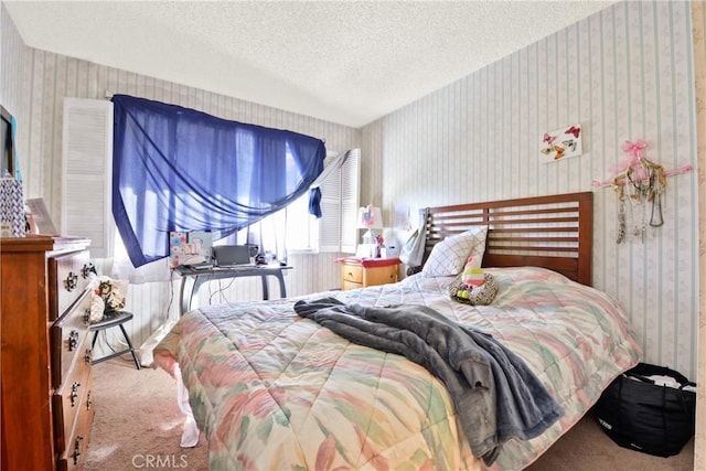 bedroom featuring light colored carpet and a textured ceiling