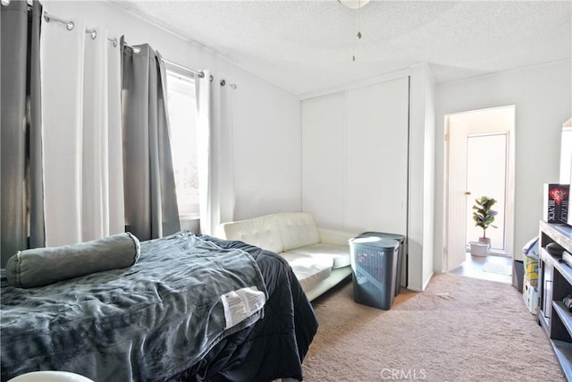 carpeted bedroom featuring a textured ceiling