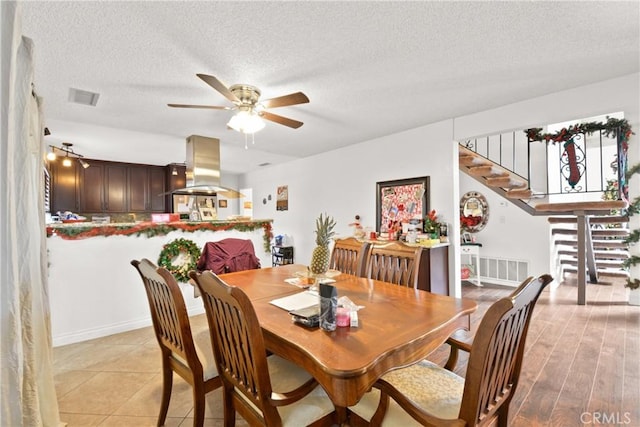 dining space featuring a textured ceiling and ceiling fan