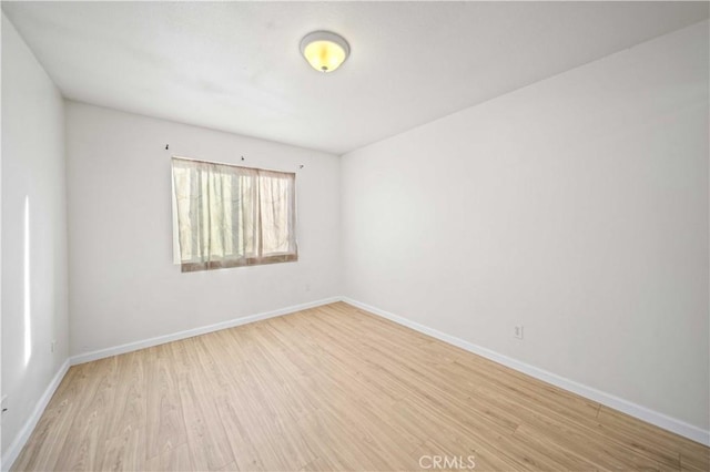 unfurnished room with light hardwood / wood-style flooring