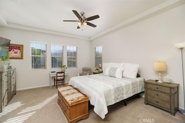 carpeted bedroom featuring multiple windows and ceiling fan