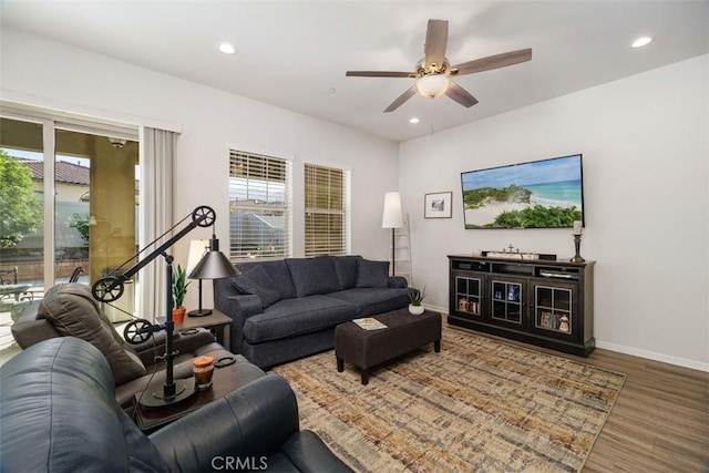 living room featuring hardwood / wood-style floors and ceiling fan