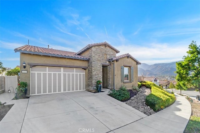 view of front of property featuring a mountain view and a garage