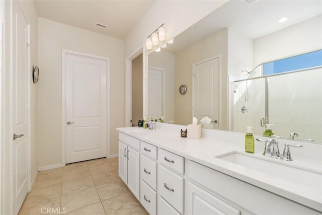 bathroom with tile patterned flooring, vanity, and a shower with shower door