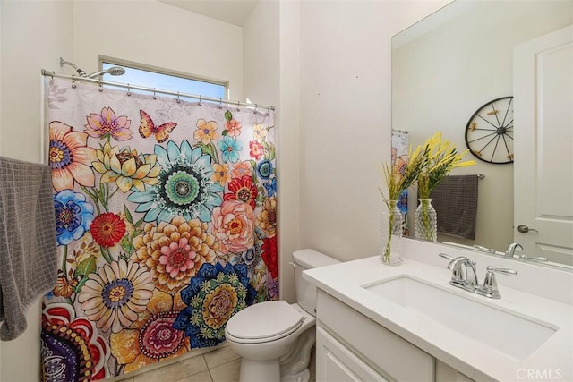 bathroom with tile patterned flooring, vanity, and toilet