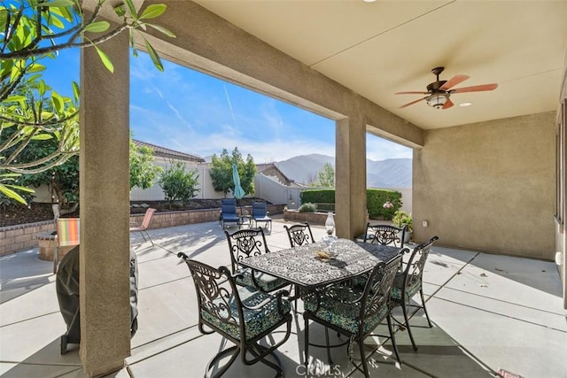 view of patio / terrace with a mountain view and ceiling fan