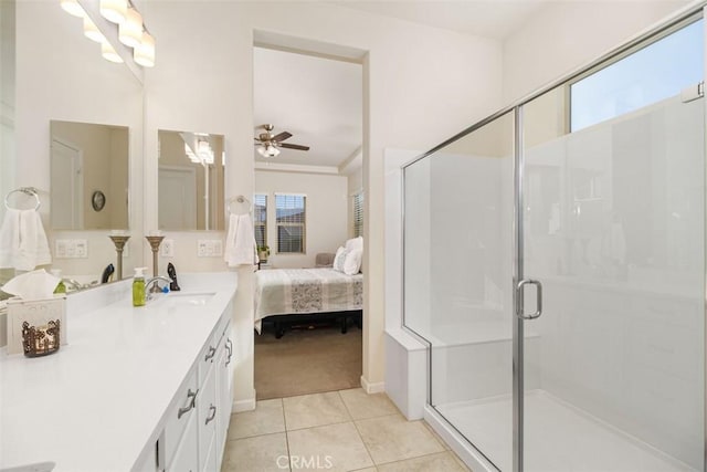 bathroom with tile patterned floors, ceiling fan, a shower with shower door, and vanity