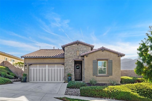 view of front of home with a mountain view and a garage