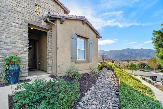 view of exterior entry featuring a mountain view