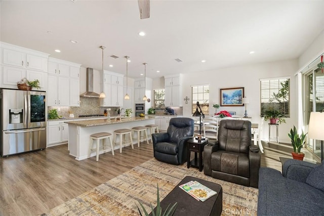 living room featuring light wood-type flooring and ceiling fan