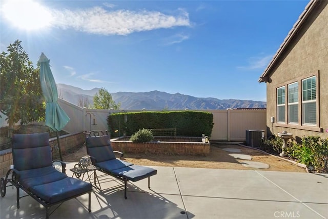 view of patio / terrace featuring a mountain view and cooling unit