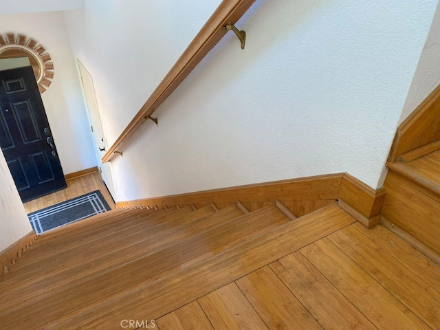 staircase with wood-type flooring