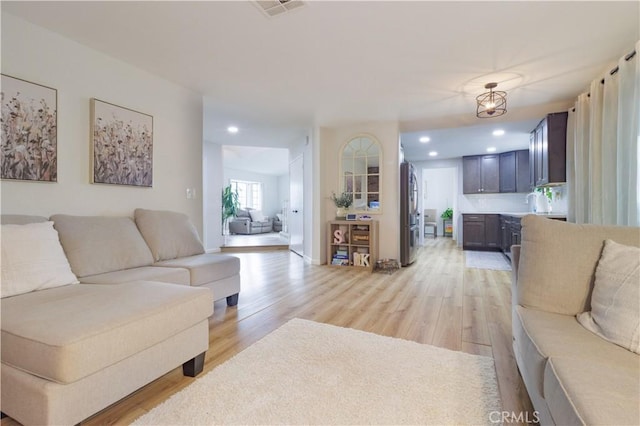 living room with light hardwood / wood-style flooring