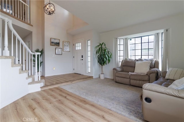 living room with wood-type flooring and an inviting chandelier