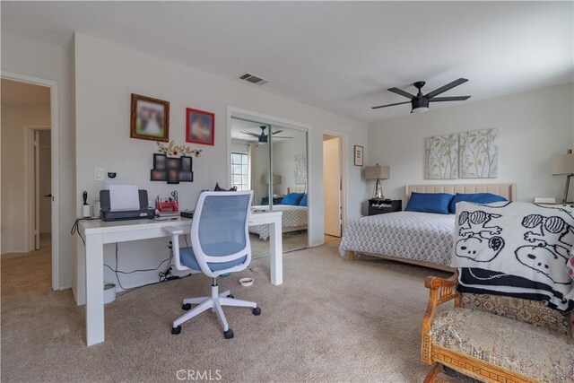 carpeted bedroom featuring ceiling fan and a closet