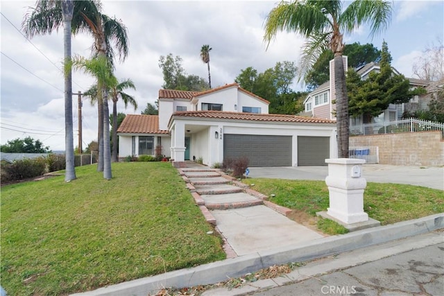 mediterranean / spanish-style home featuring a front yard and a garage