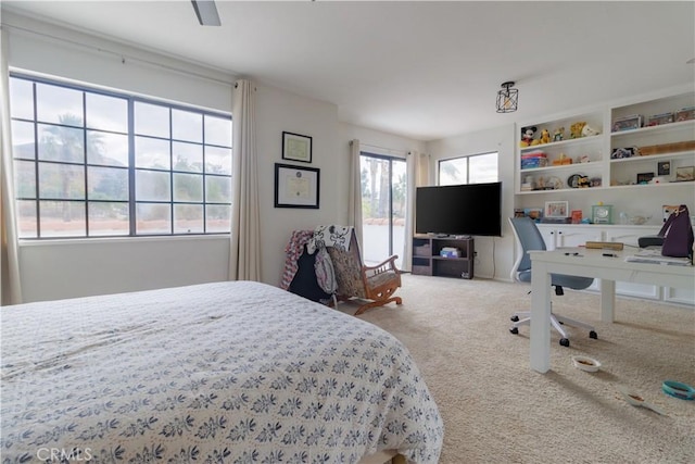 bedroom with carpet floors, multiple windows, and ceiling fan