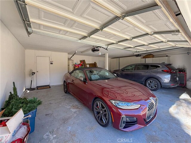 garage with a garage door opener and secured water heater