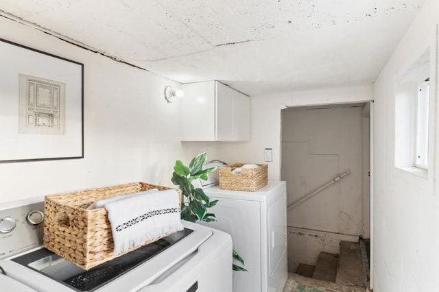 clothes washing area with washing machine and dryer