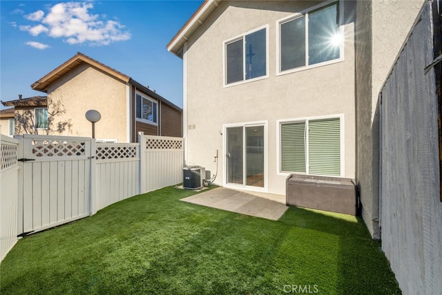 back of house with a patio area, a yard, and central air condition unit