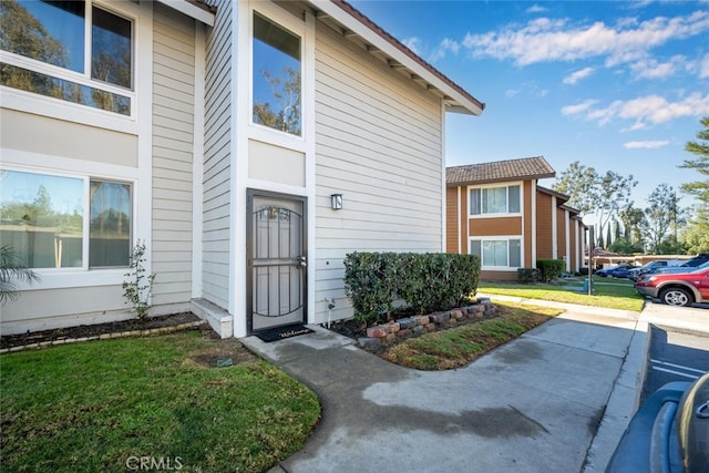 entrance to property with a lawn