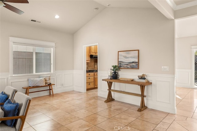 interior space with lofted ceiling, light tile patterned floors, ceiling fan, and a healthy amount of sunlight