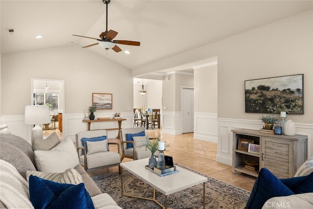 living room with ceiling fan, light tile patterned floors, and lofted ceiling