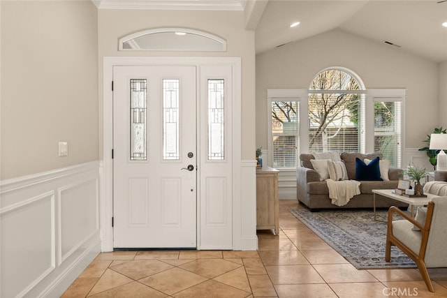 entrance foyer featuring vaulted ceiling and light tile patterned flooring