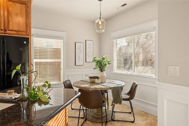 dining area with light tile patterned floors