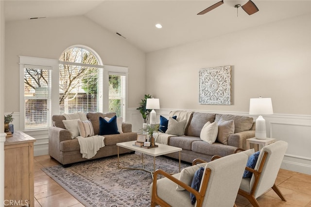 living room with ceiling fan, light tile patterned floors, and lofted ceiling