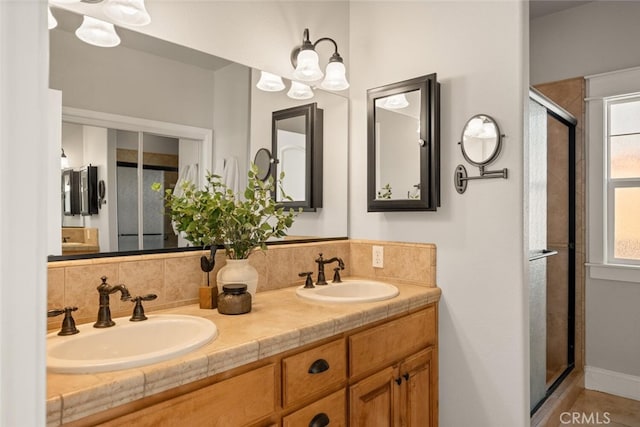 bathroom with walk in shower, an inviting chandelier, vanity, and tasteful backsplash