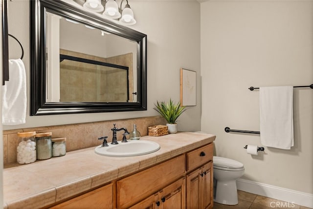 bathroom with an enclosed shower, vanity, toilet, and tile patterned flooring