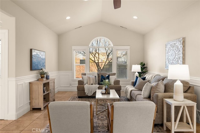 living room with vaulted ceiling, ceiling fan, and light tile patterned floors